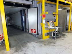 Vertical-storing leveler allows loading dock doors to close on the pit floor.